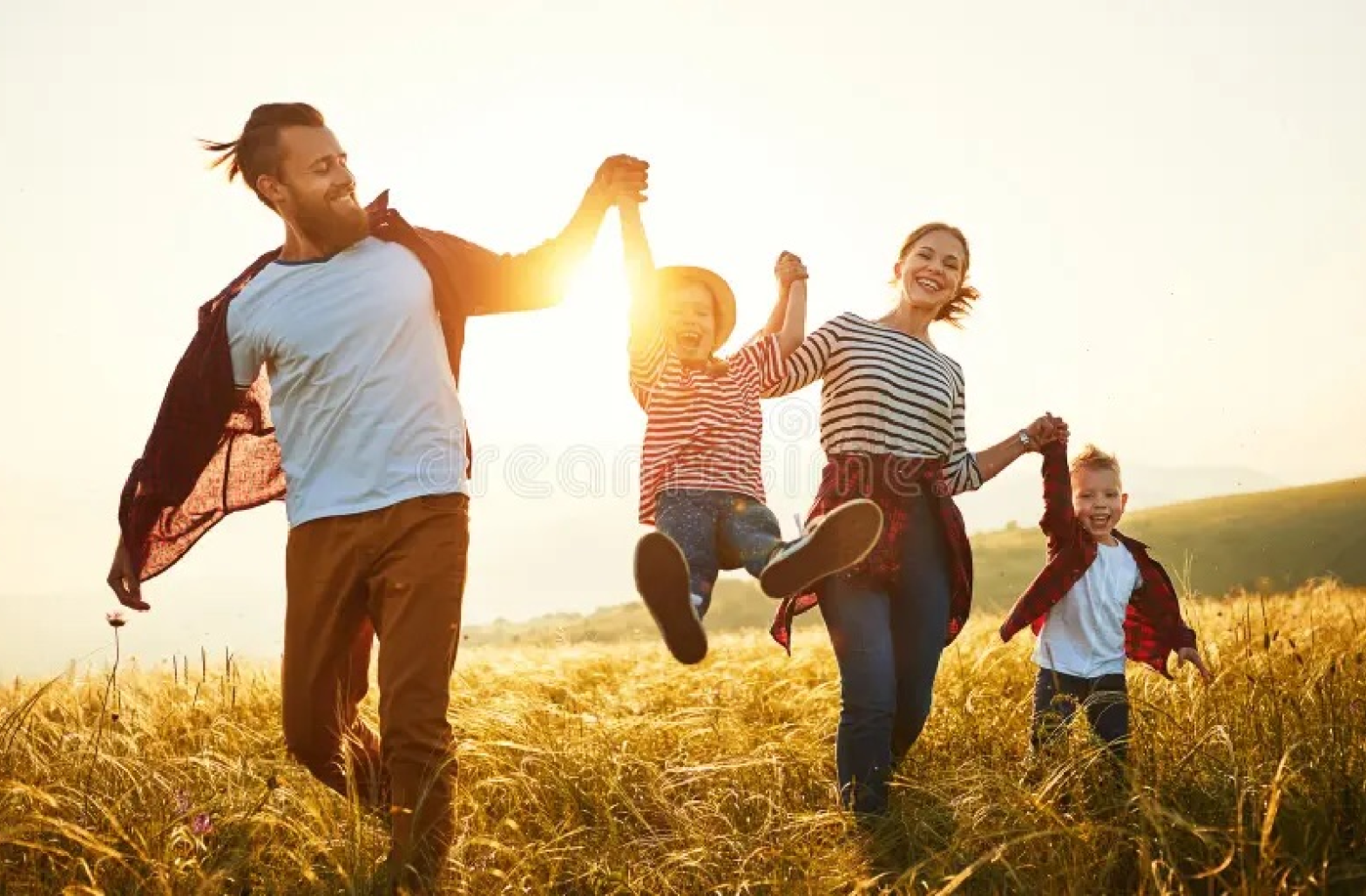 happy family holding hands outdoors
